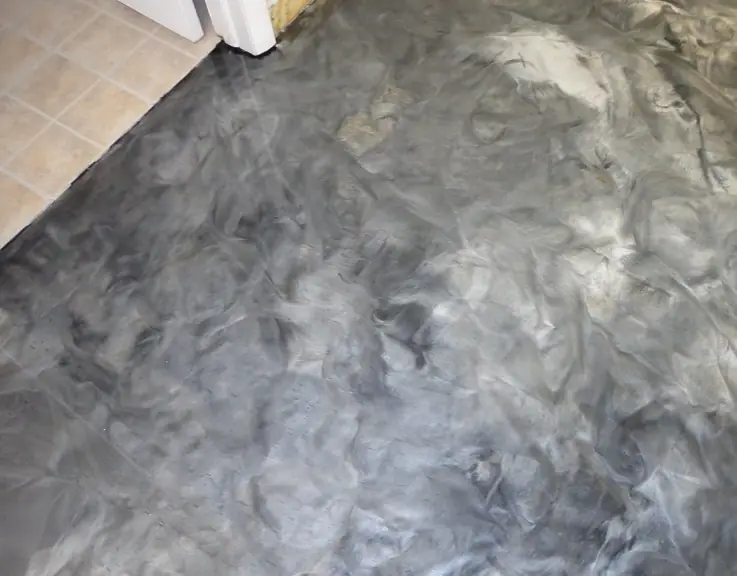 A metallic epoxy floor with black and pearl swirls.